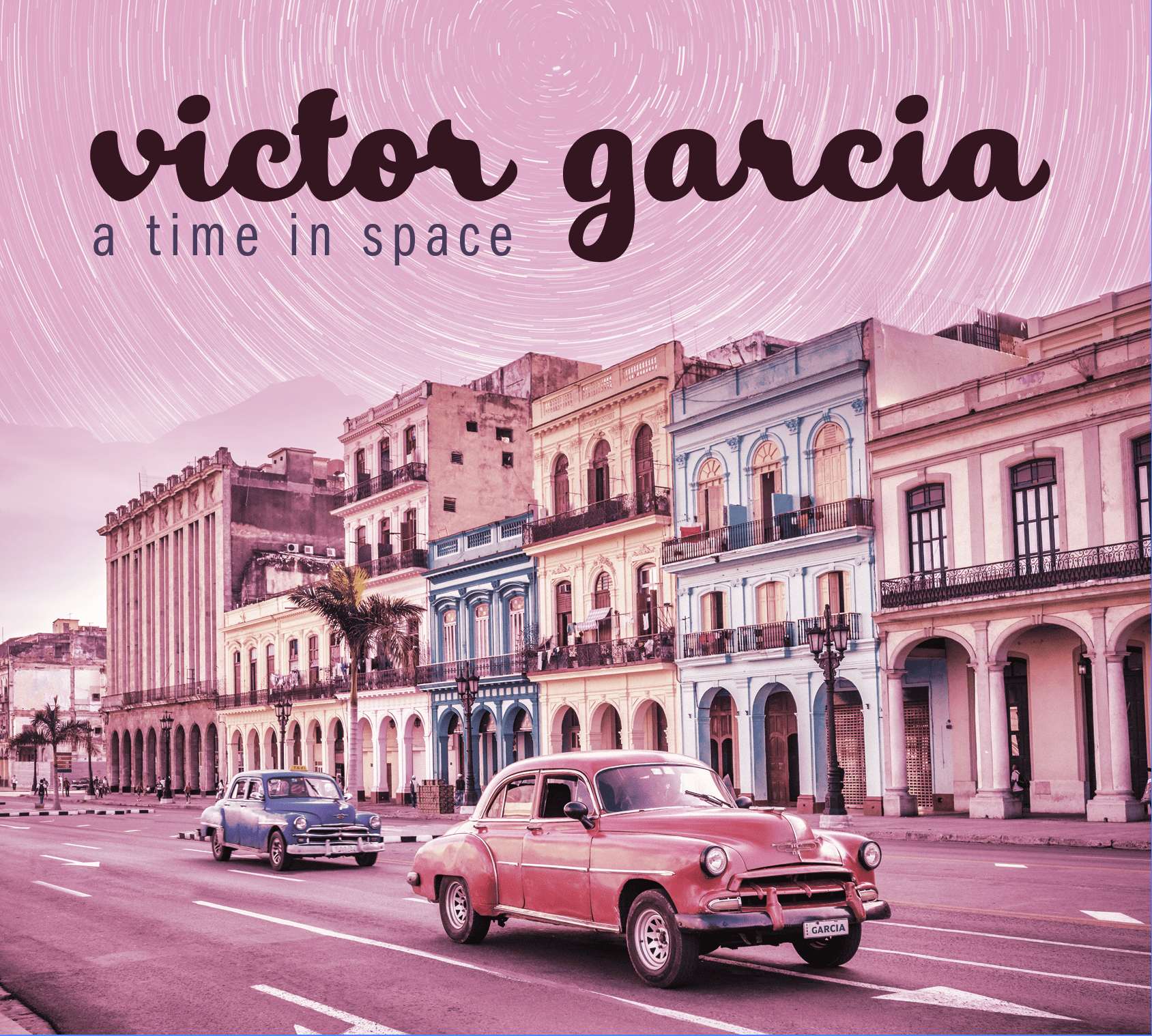 Album cover for A Time in Space by Victor Garcia. The image features a vibrant, pink-tinted street scene with colorful colonial-style buildings and vintage cars driving in the foreground. The sky above shows swirling star trails. The artist's name, Victor Garcia, appears in bold, cursive text at the top, with the album title a time in space in a modern sans-serif font below it.